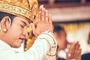 Indonesian man prayer marga bali